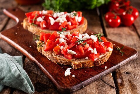 Mediterranean breakfast table with toast, tomatoes and olive oil